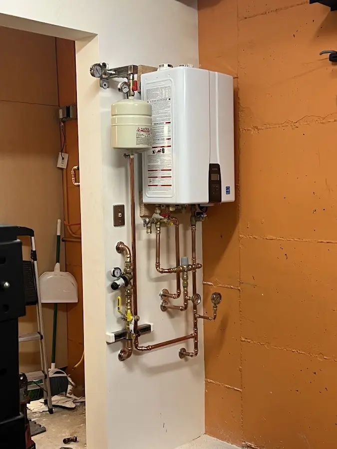 Plumbing technician inspecting water heater connections in Placerville